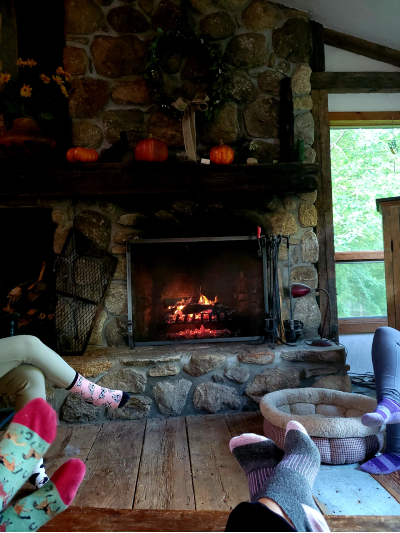 RI B and B guests sitting by a cozy fire in their PJs